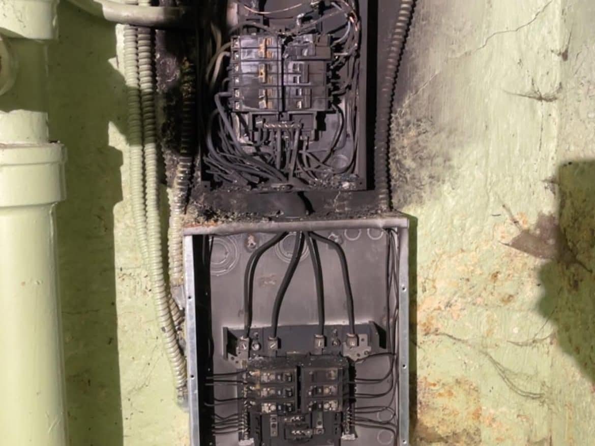 Melted breakers and scorched wiring inside a failed electrical panel at a Vancouver, WA home, before Power Professor replaced it
