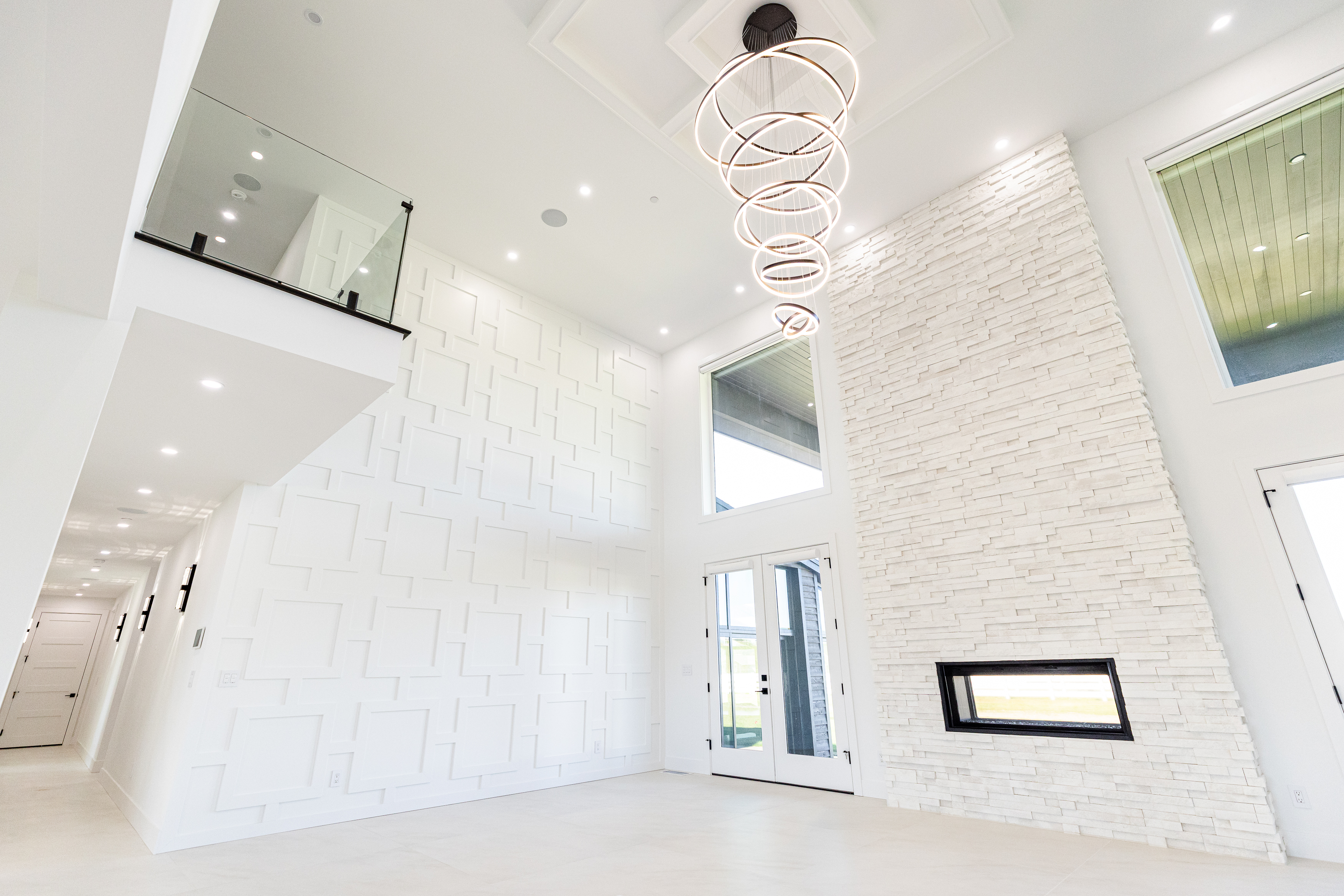 Open-concept living room and kitchen with custom residential lighting
