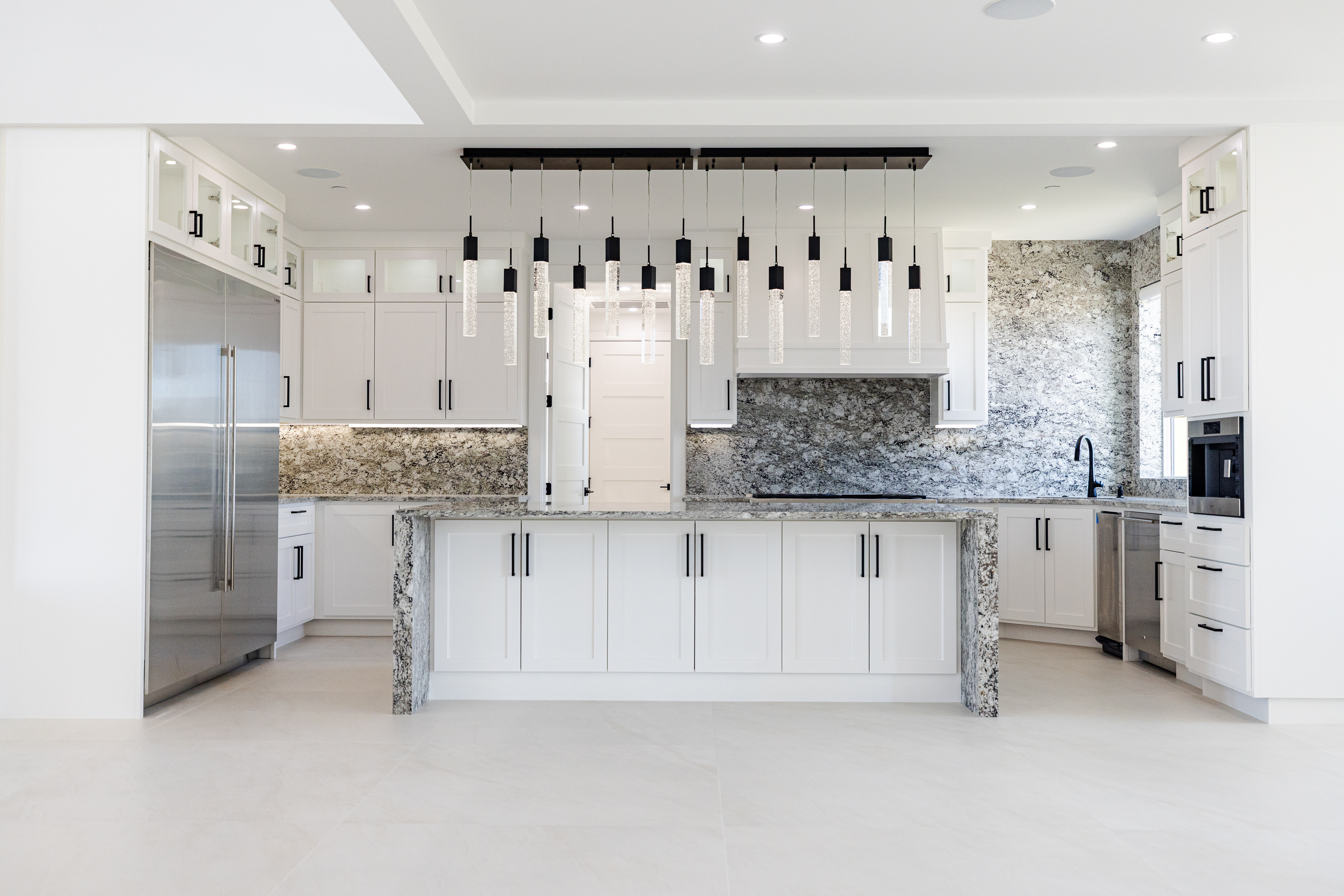 Luxury kitchen electrical installation with custom pendant lights and recessed lighting