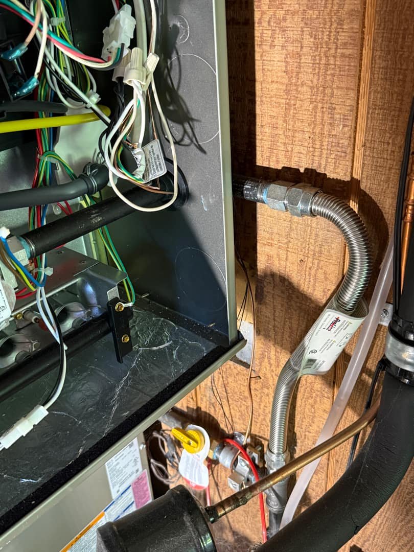 Electrical panel connections displaying wires, conduit, and a bonding jumper for grounding.