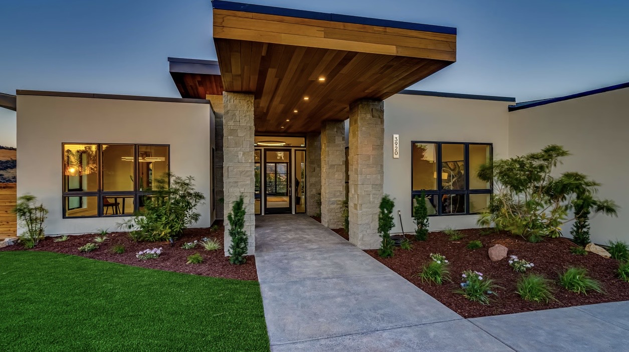 Luxury home exterior with architectural lighting and illuminated entrance