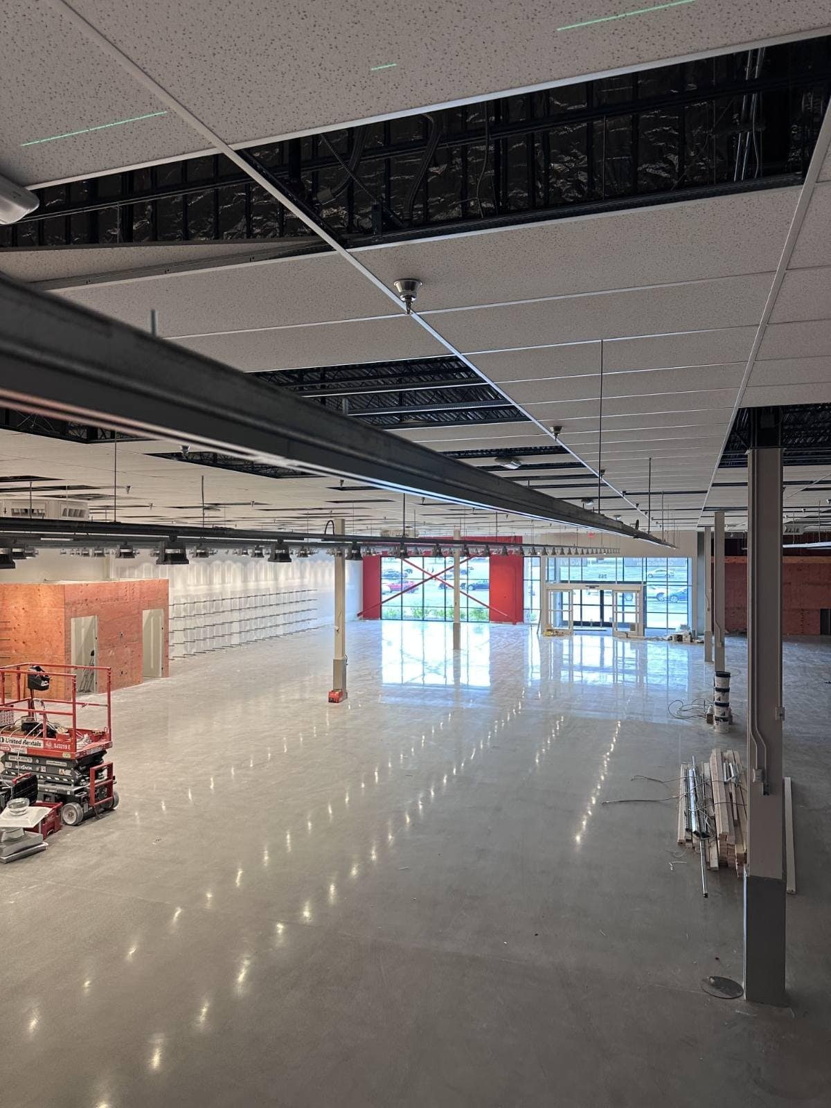 Finished sales floor of a 13,000 sq ft retail store with continuous track lighting runs and high-bay accent heads installed by Power Professor