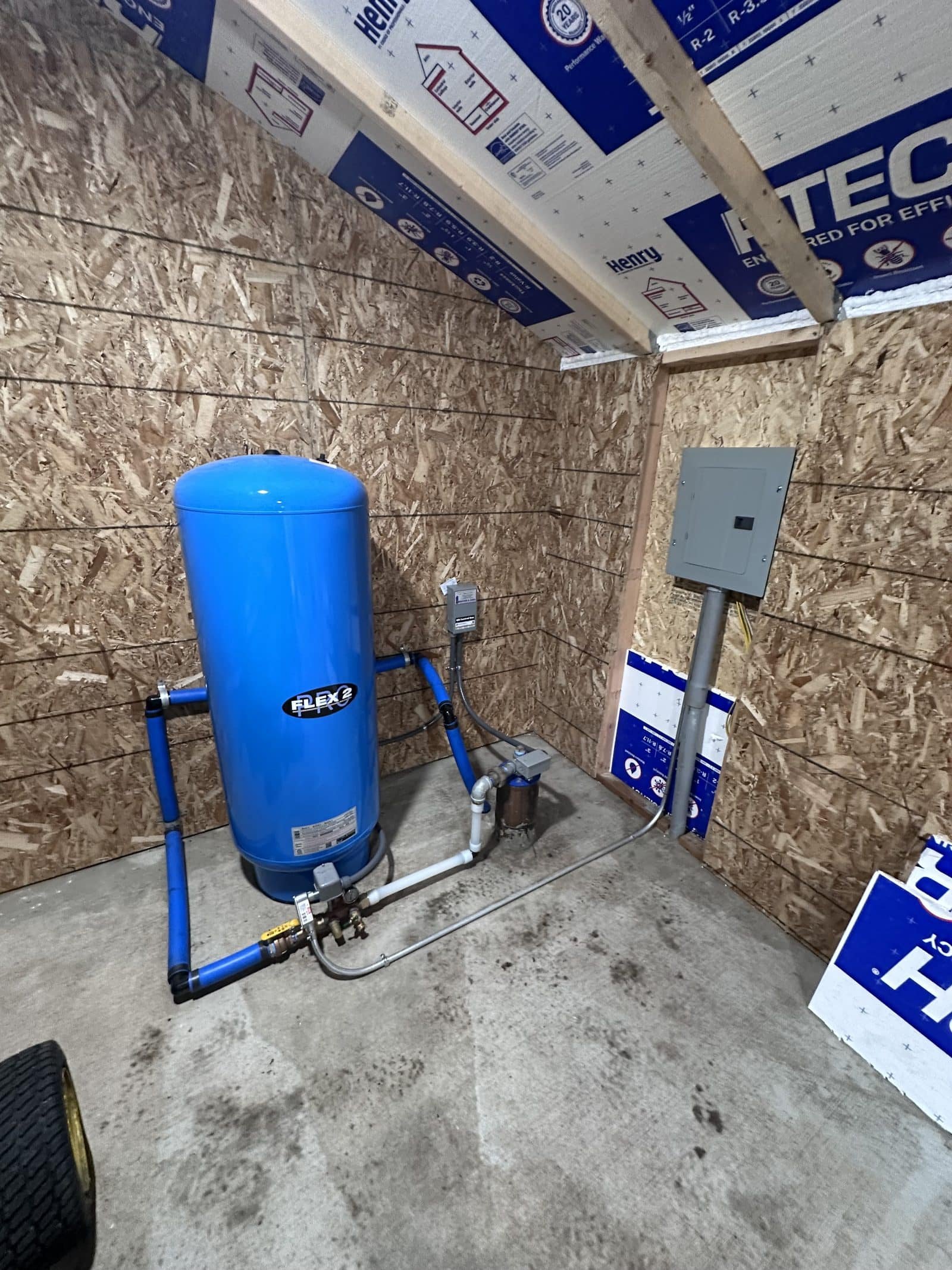 Insulated well pump house with a new electrical subpanel, pump control box, pressure switch, and Flexcon Flex2 Pro pressure tank